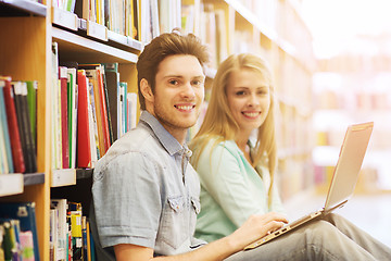 Image showing happy students with laptop in library