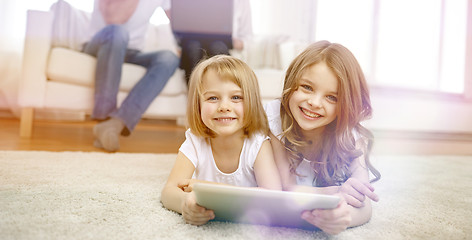 Image showing happy little girls with tablet pc computer at home