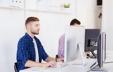 Image showing creative man or student with computer at office