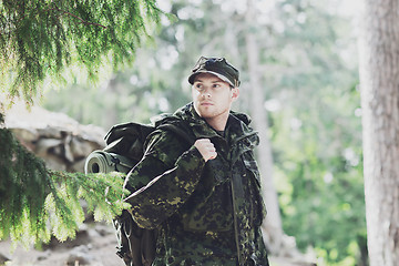 Image showing young soldier with backpack in forest