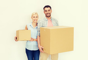 Image showing couple with cardboard boxes moving to new home