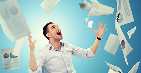 Image showing businessman with falling papers