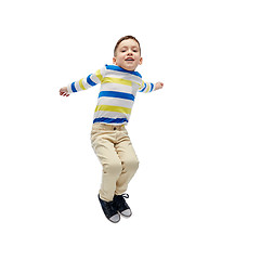 Image showing happy little boy jumping in air
