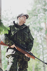 Image showing young soldier or hunter with gun in forest