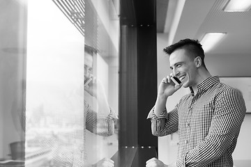 Image showing young business man using smart phone at office