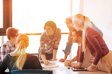 Image showing startup business team on meeting at modern office with sunset in