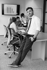 Image showing young business man with tablet at office meeting room