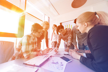 Image showing startup business team on meeting at modern office with sunset in