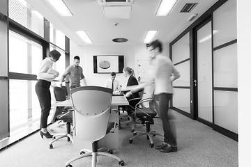 Image showing business people group entering meeting room  motion blur