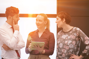 Image showing young business people group working on tablet computer with sunr