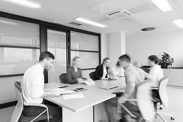 Image showing business people group entering meeting room  motion blur