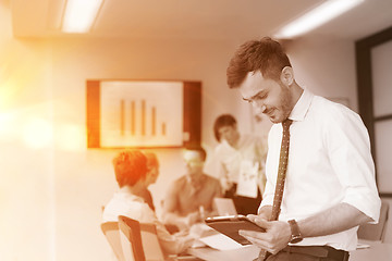 Image showing young business man with tablet at office meeting room