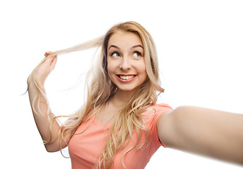 Image showing smiling young woman taking selfie