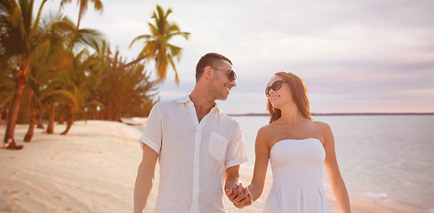 Image showing happy smiling couple over summer beach and sea