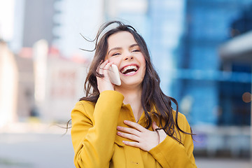 Image showing smiling young woman or girl calling on smartphone