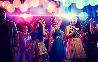 Image showing smiling friends dancing in club