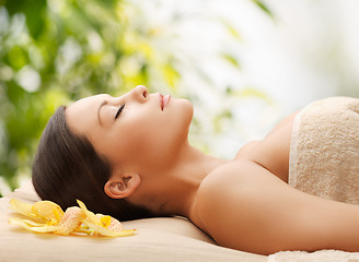 Image showing woman in spa lying on the massage desk