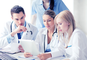 Image showing group of doctors looking at tablet pc