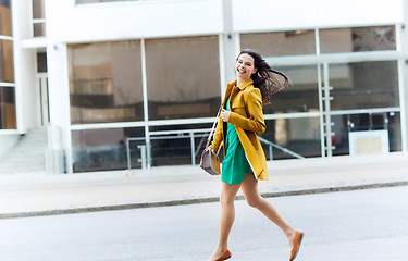 Image showing happy young woman or teenage girl on city street