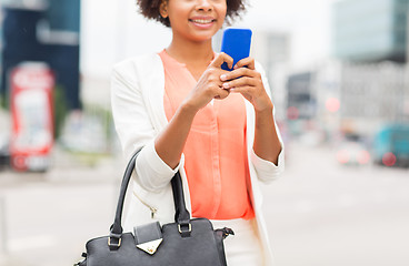 Image showing close up of african woman with smartphone in city