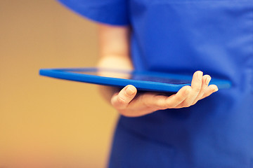 Image showing close up of female doctor or nurse with tablet pc