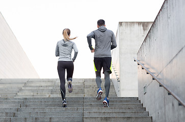 Image showing couple running upstairs on city stairs