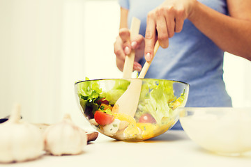 Image showing close up of woman cooking vegetable salad at home