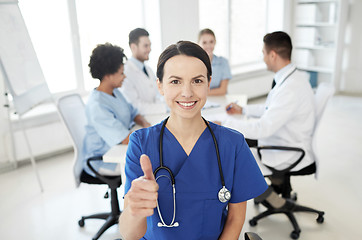 Image showing happy doctor over group of medics at hospital