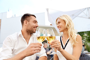 Image showing happy couple drinking wine at open-air restaurant