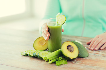 Image showing close up of woman hands with juice and vegetables