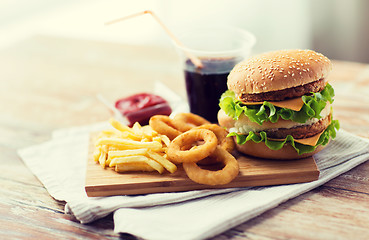 Image showing close up of fast food snacks and drink on table