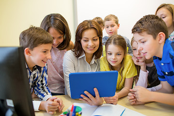 Image showing group of kids with teacher and tablet pc at school