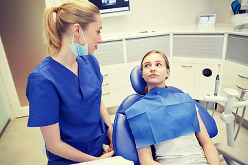 Image showing happy female dentist with patient girl at clinic