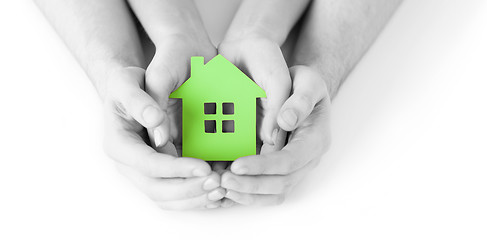 Image showing man and woman hands with green paper house