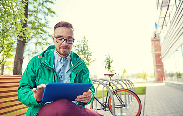 Image showing happy young hipster man with tablet pc and bike