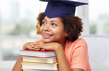 Image showing happy african bachelor girl with books at home