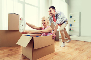 Image showing couple with cardboard boxes having fun at new home