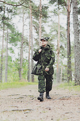 Image showing young soldier or hunter with gun in forest