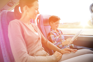 Image showing happy family with tablet pc sitting in travel bus