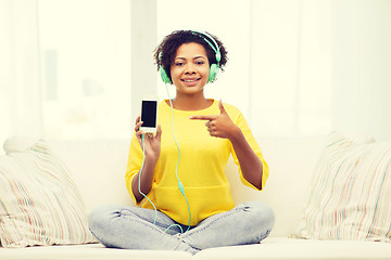 Image showing happy african woman with smartphone and headphones