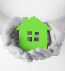 Image showing hands holding green paper house