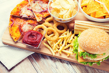 Image showing close up of fast food snacks on wooden table