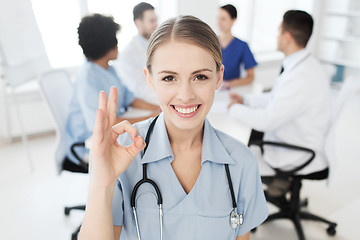 Image showing happy doctor over group of medics at hospital