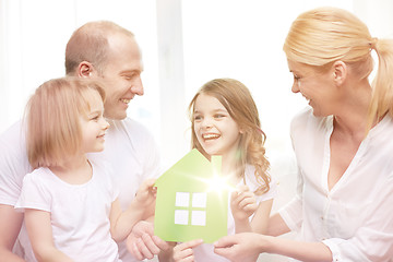 Image showing smiling parents and two little girls at new home