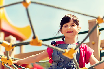 Image showing happy little girl climbing on children playground