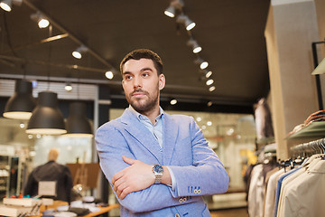 Image showing happy young man in jacket at clothing store