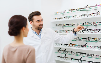 Image showing woman and optician showing glasses at optics store