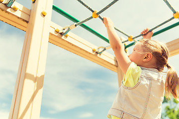 Image showing close up of girl climbing on children playground