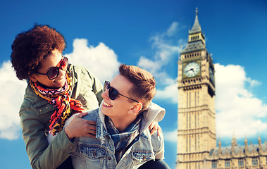 Image showing happy teenage couple having fun over big ben tower