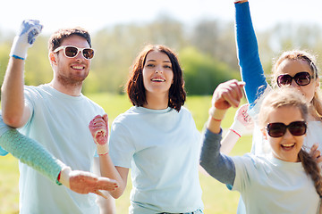 Image showing group of volunteers celebrating success in park